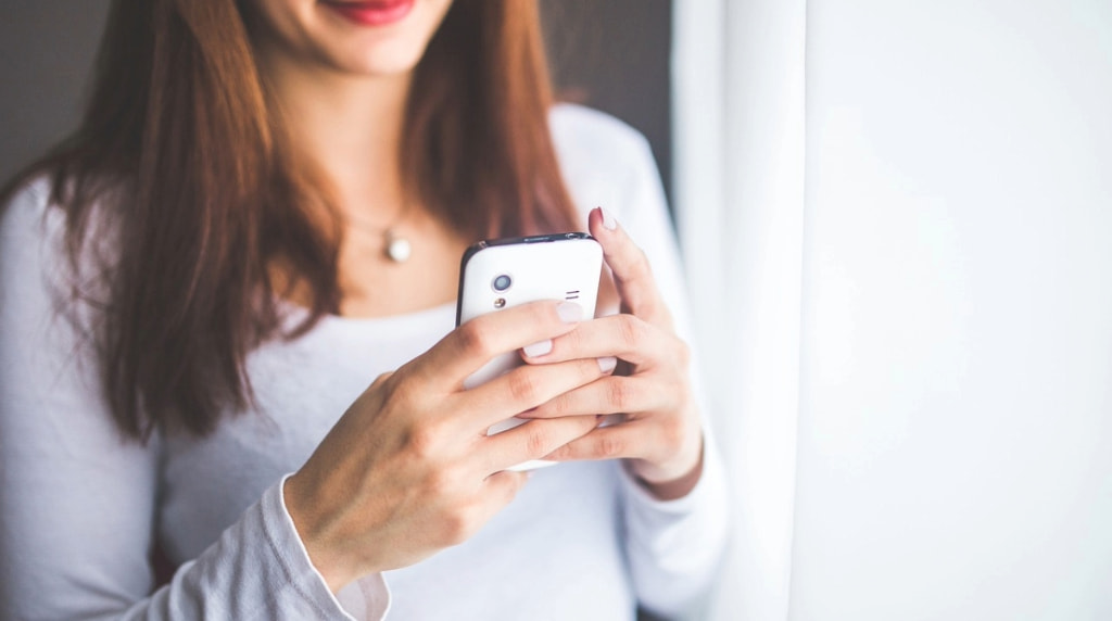 A Woman Playing Casino Games on Her Mobile Phone